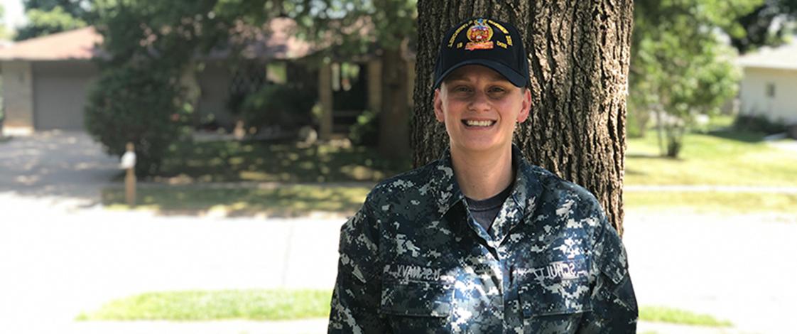 Dana Schultz, standing in her Navy uniform